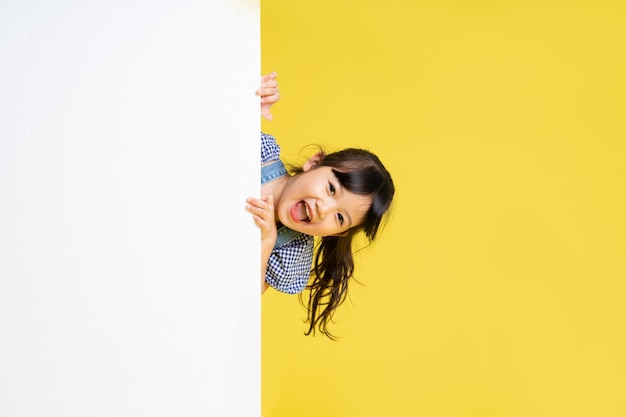 Beautiful asian girl portrait isolated on yellow background