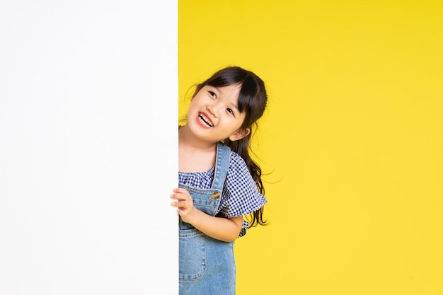 Beautiful asian girl portrait isolated on yellow background