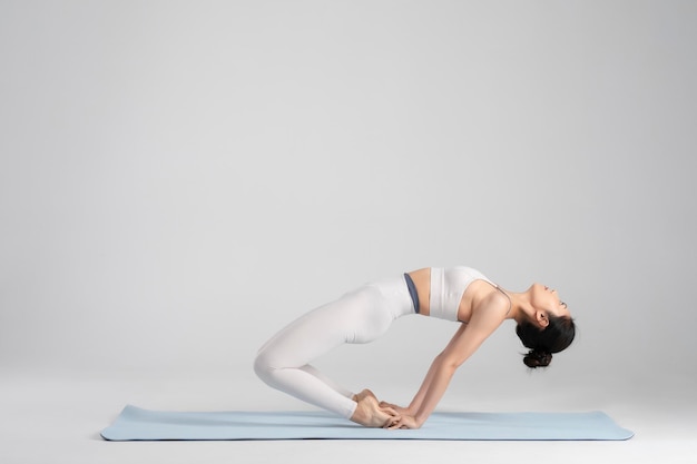 Beautiful Asian girl practicing yoga