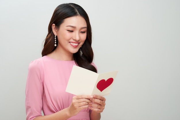 Beautiful asian girl reads love letter. Happy woman day.