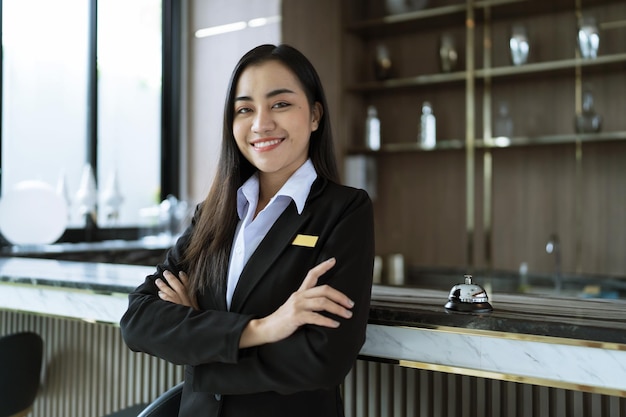 Photo beautiful asian hotel receptionist in uniforms at desk in lobby friendly and welcome staff in hotel reception counter