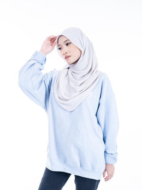 A beautiful Asian Muslim female model wearing modern and stylish casualwear with hijab isolated