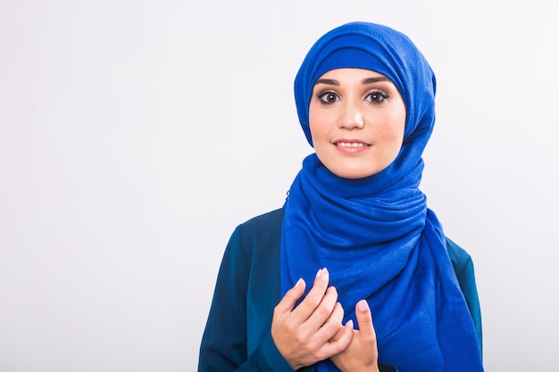 Beautiful asian muslim woman model posing on white background in studio.