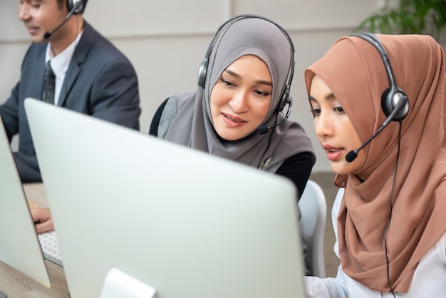 Beautiful Asian muslim women working in call center office