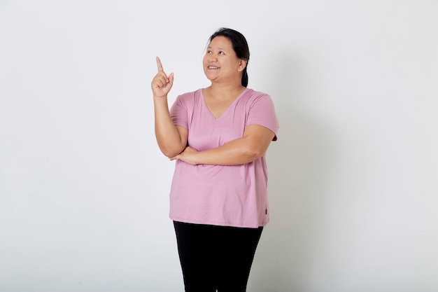 Beautiful Asian plussize woman smiles with positive emotion feeling happy and proud of her body over