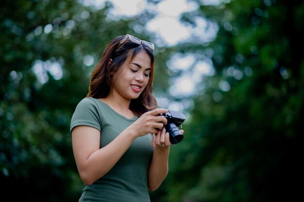 Beautiful Asian tourist and her personal camera female photographer Surround Milleles