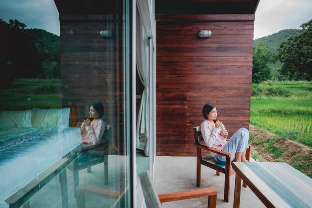 A beautiful Asian tourist sits room terrace