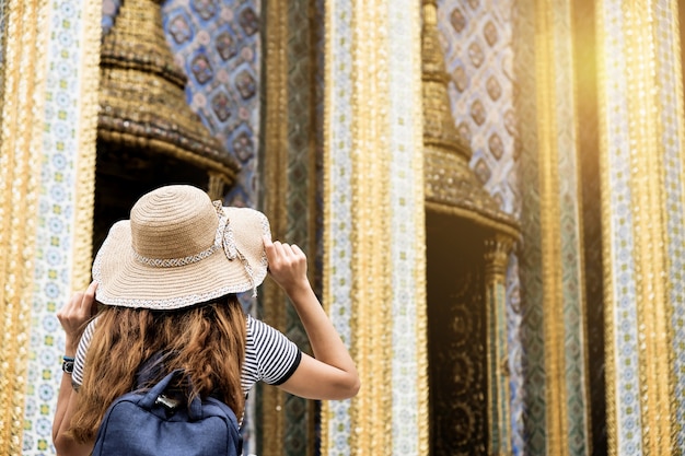 Beautiful Asian tourists visiting Wat Phra Kaew.