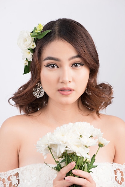 Beautiful asian woman bride on grey background. Closeup portraits with a professional makeup