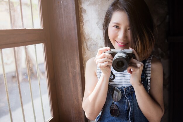 beautiful asian woman  casual costume with camera and travel stuff 