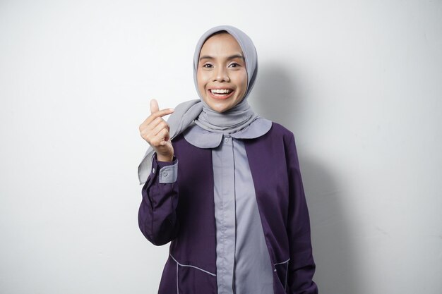 Beautiful Asian woman in casual shirt smiling happy and looking confident isolated by white background