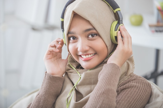 Beautiful asian woman enjoying music