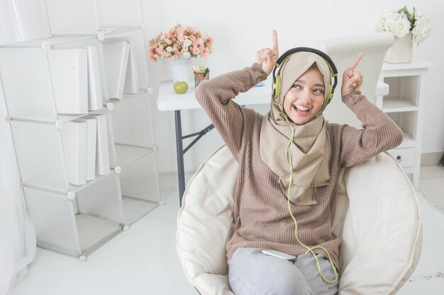 Beautiful asian woman enjoying music