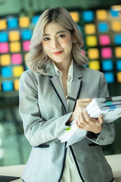 Beautiful Asian woman freelance startup successful small and medium enterprise business owner SME stand with document folder SME entrepreneur business asian woman work at home office online startup