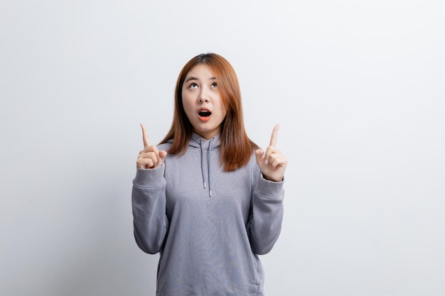 Beautiful Asian woman gesturing for advertisement editing on isolated background portrait concept used for advertisement and signage isolated over white background copy space