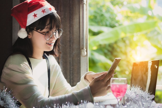 beautiful Asian woman, girl using smartphone in new year holiday with happy.