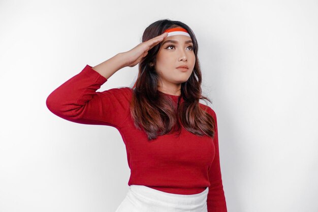 Beautiful Asian woman giving salute celebrate Indonesian independence day on August 17 isolated over white background