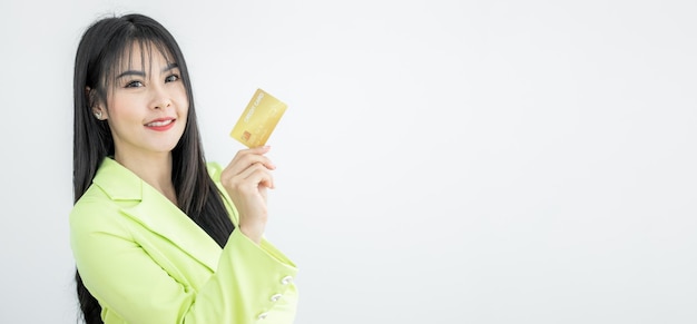 Beautiful Asian woman holding credit card on white background Asian woman smiling showing presenting credit card Woman holding bank business credit card copy space