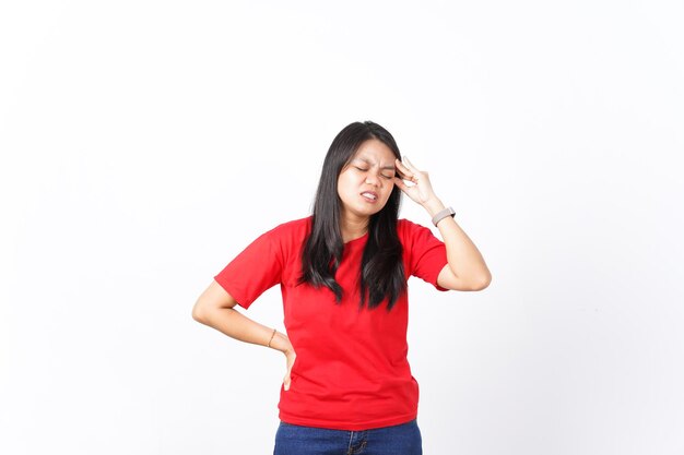 beautiful Asian woman holds her head in pain expressing a headache against a white background