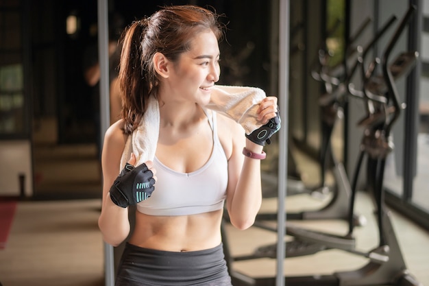 Beautiful asian woman is doing exercise in the gym