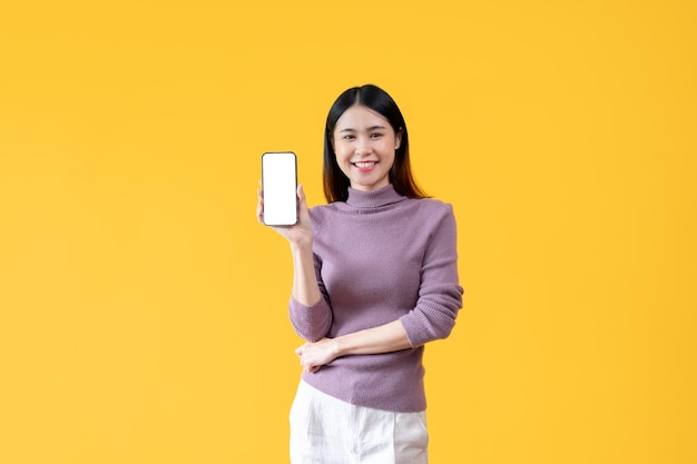 A beautiful Asian woman is showing a smartphone white screen mockup to the camera