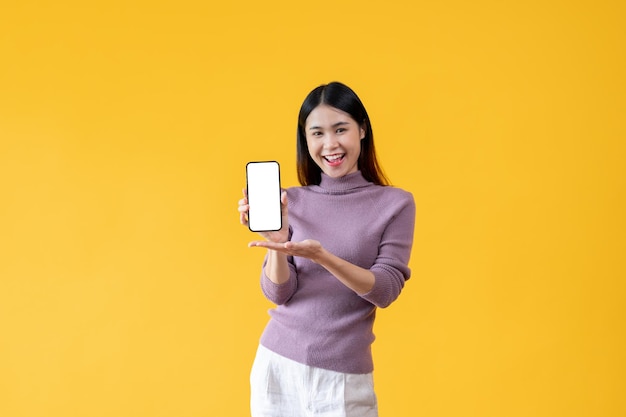 A beautiful Asian woman is showing the white screen of a smartphone in her hand to the camera