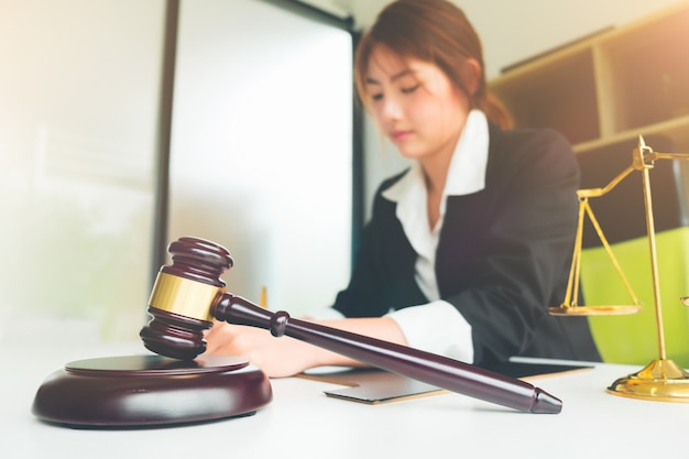 Beautiful asian woman lawyer working and gavel in front