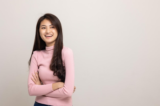 Beautiful asian woman look into blank space Smiling female wearing pink shirt on isolated white background Attractive Teenager girl looking at empty space for text feeling excited and surprised