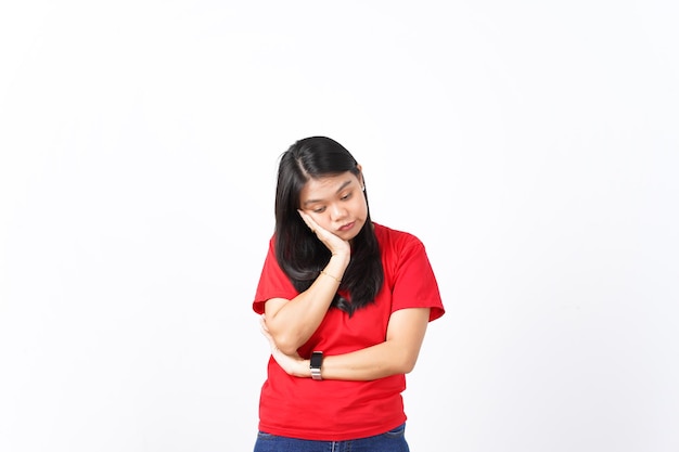 beautiful Asian woman looks tired and sleepy leaning on one palm set against a white background