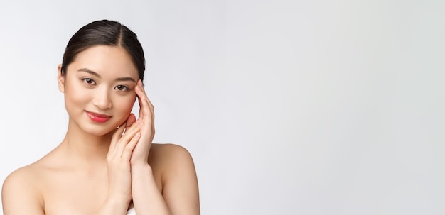 Beautiful asian woman makeup of cosmetic girl hand touch cheek and smile face of beauty perfect with wellness isolated on white background