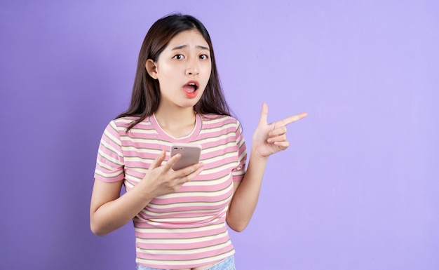 Beautiful asian woman portrait, isolated on purple background