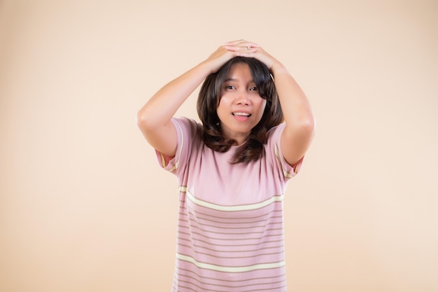 Beautiful asian woman pretty girl make a hand on her head