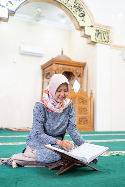 Beautiful asian woman read Quran