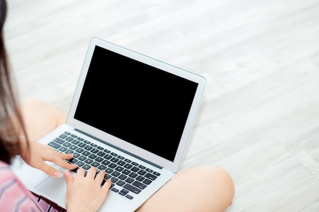 beautiful asian woman setting using laptop computer