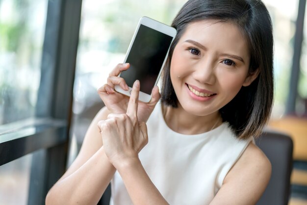 beautiful asian woman show blank screen smartphone