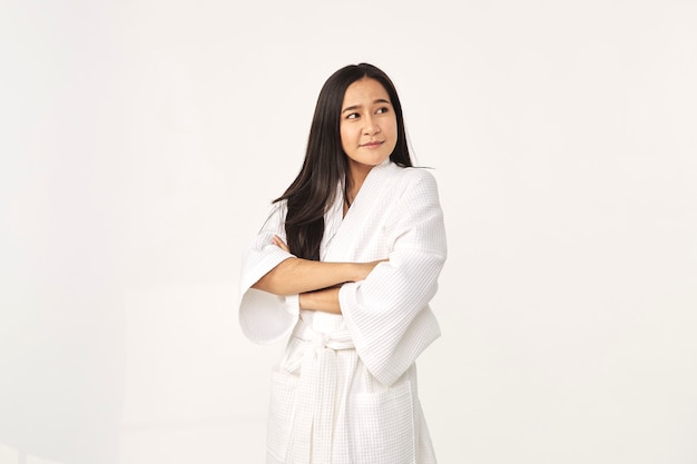 Beautiful Asian woman wearing bathrobe smile with clean and fresh skin