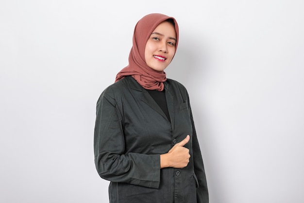 Beautiful asian woman wearing hijab very happy and excited doing thumbs up gesture isolated white