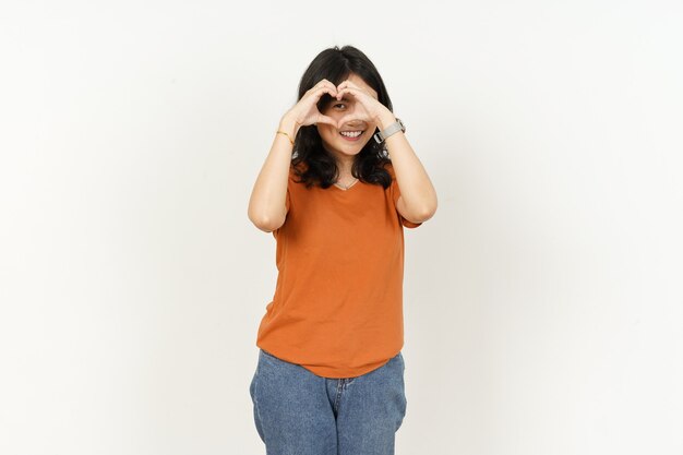 Beautiful Asian Woman Wearing Orange Color TShirt make and showing love heart hand sign