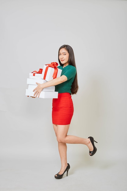 Beautiful Asian woman with many presents isolated