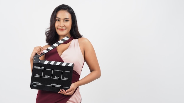 Beautiful asian woman with tan skin and hand's holding clapper board or movie slate use in video production ,film, cinema ,movies industry on white background.