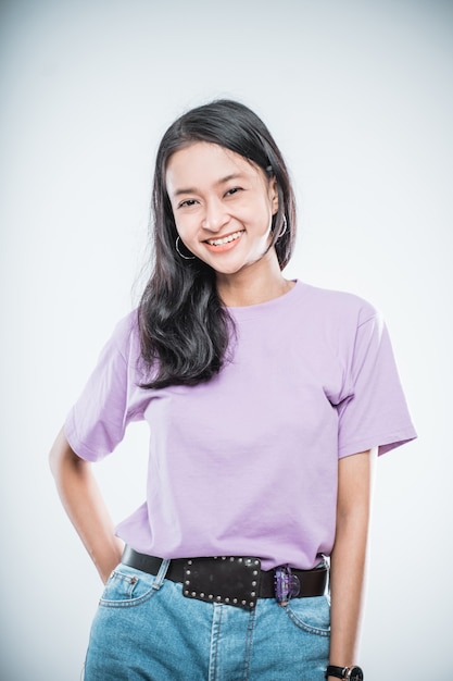 Beautiful asian young girl with jeans pants isolated on a white background