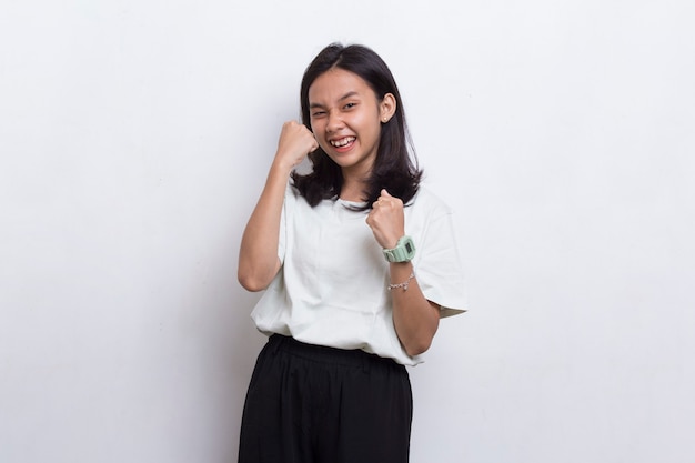 Beautiful asian young woman happy and excited celebrating victory expressing big success