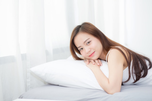 Beautiful asian young woman sleeping lying in bed 