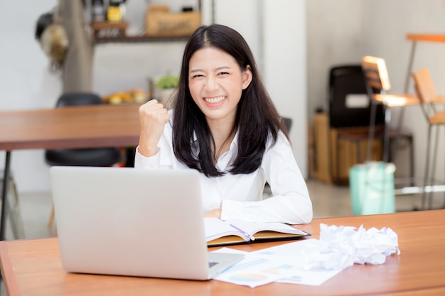 Beautiful asian young woman working online on laptop