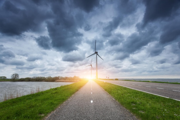 Beautiful asphalt road with wind turbines