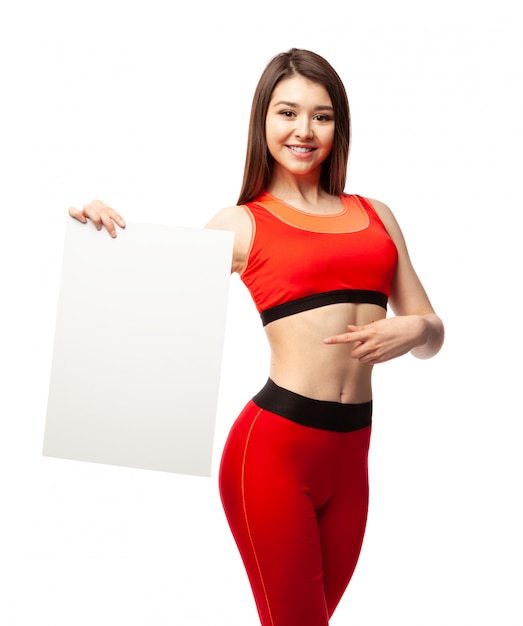 Beautiful athletic woman holding a poster and showing it.