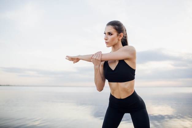 Beautiful athletic woman in sportswear training