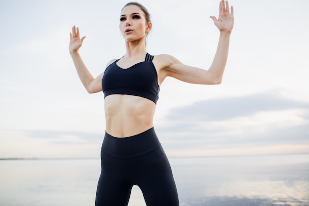 Beautiful athletic woman in sportswear training