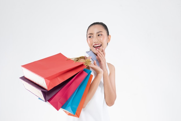 Photo beautiful attractive asian woman smile and holding shopping bags feeling so happiness and enjoy