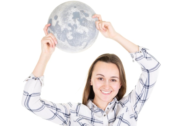 Beautiful attractive girl with moon in the hands under white background